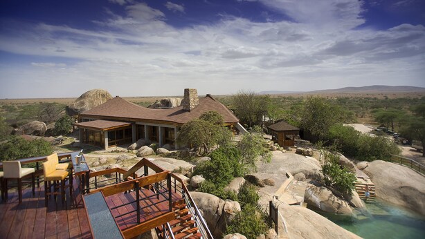 A resort with a large building surrounded by natural rock formations and sparse vegetation. - Seronera Wildlife Lodge (Serengeti)