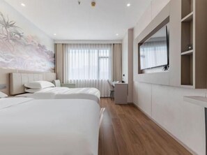 A hotel room with two beds, a desk, a chair, a TV, and a large window with curtains.