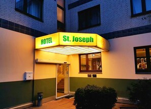 A hotel entrance with a sign reading "St. Joseph Hotel."