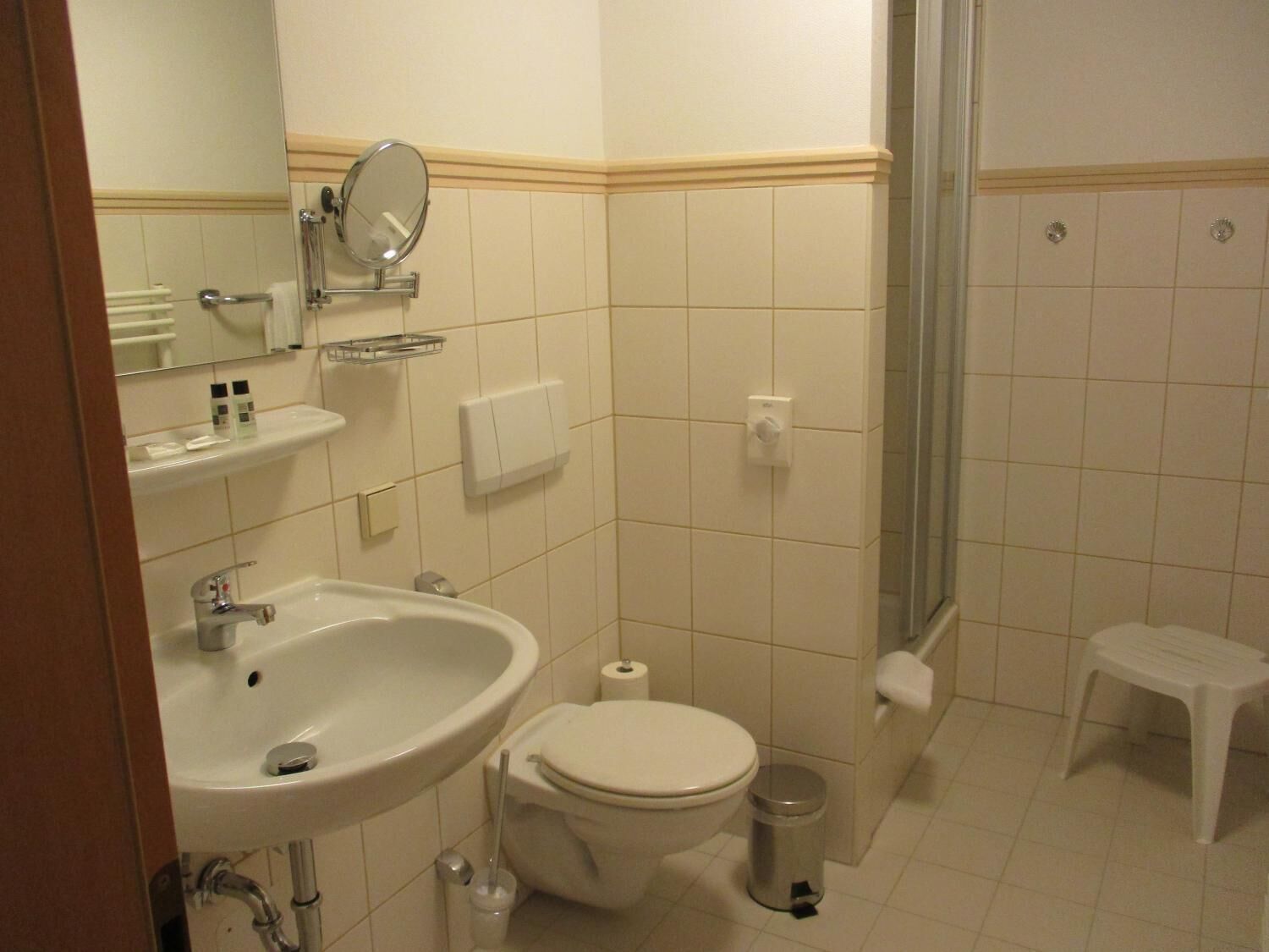 A bathroom with a sink, toilet, and shower.