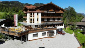 A multi-story building with a restaurant on the ground floor and a pension on the upper level. - Hotel Schweizerhof (Wildschönau)