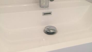 A bathroom sink with a chrome faucet and a single basin.