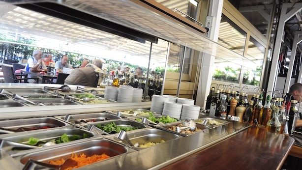 A buffet area with various food options and condiments. - Casagrande-Grosshaus (Laives)