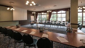 A conference room with a long table, multiple chairs, and a large window with curtains. - Jembo Park (Jena)
