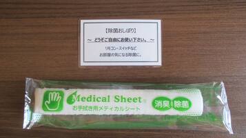 A medical sheet and a card with Japanese text on a wooden surface.