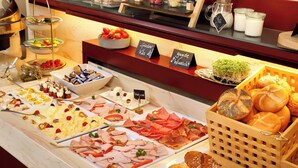 A buffet with various food items including meats, cheeses, and breads. - Rosi Boutique Hotel (Regensburg)