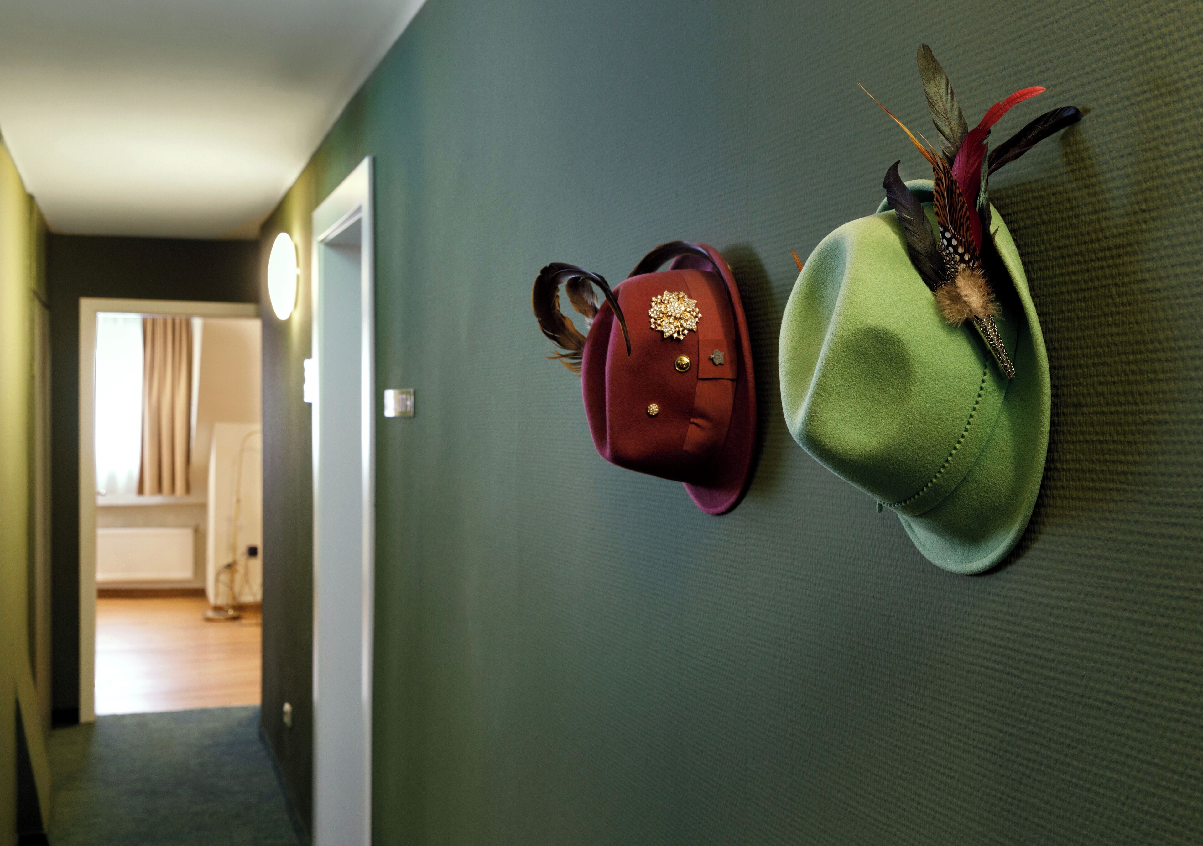 Dos sombreros colgados en una pared de un pasillo.