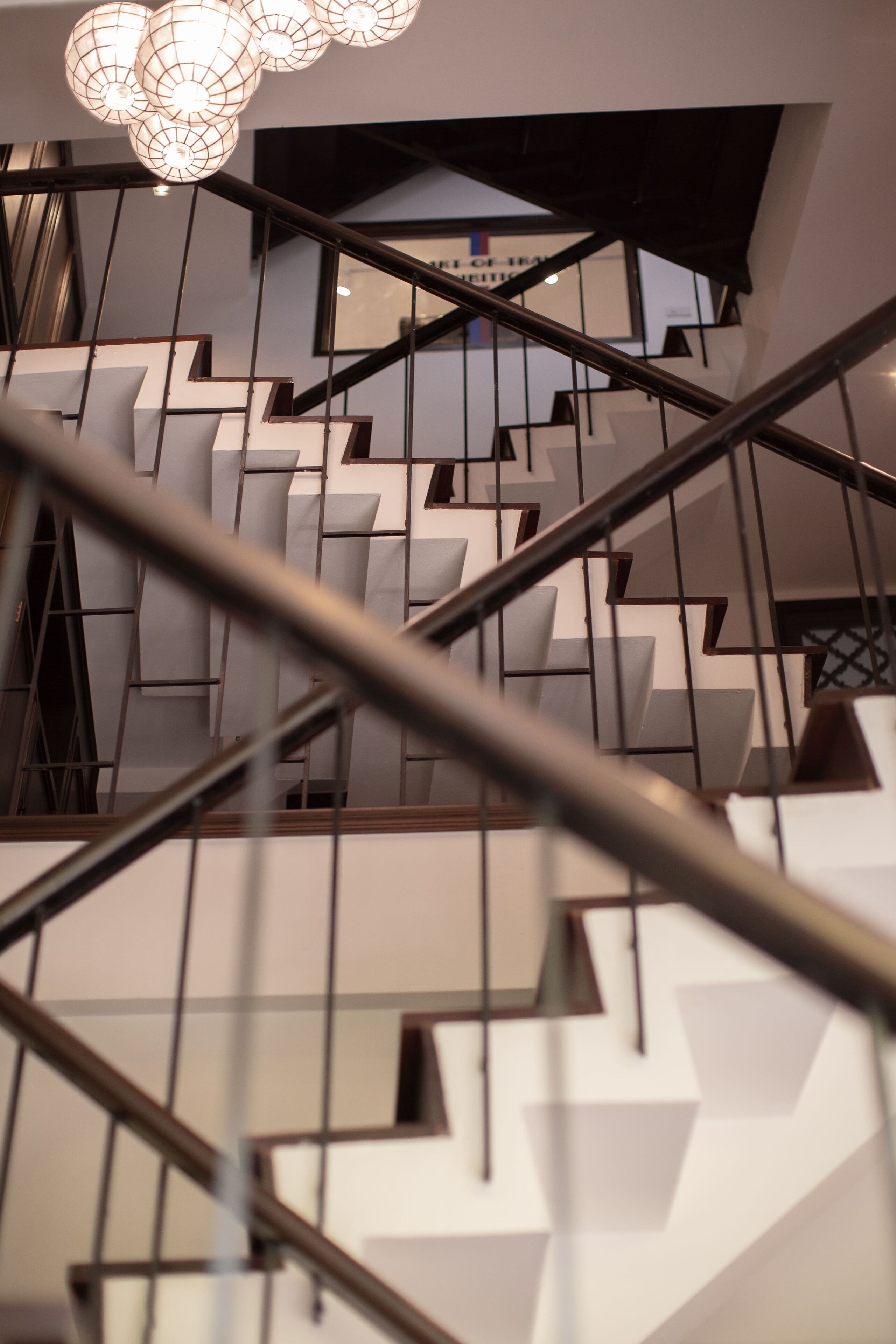 A modern staircase with geometric patterns and metal railings.