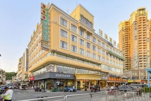 A multi-story hotel with a prominent entrance, a visible restaurant, and a large parking area. - Wanghailou Hotel (Huizhou)
