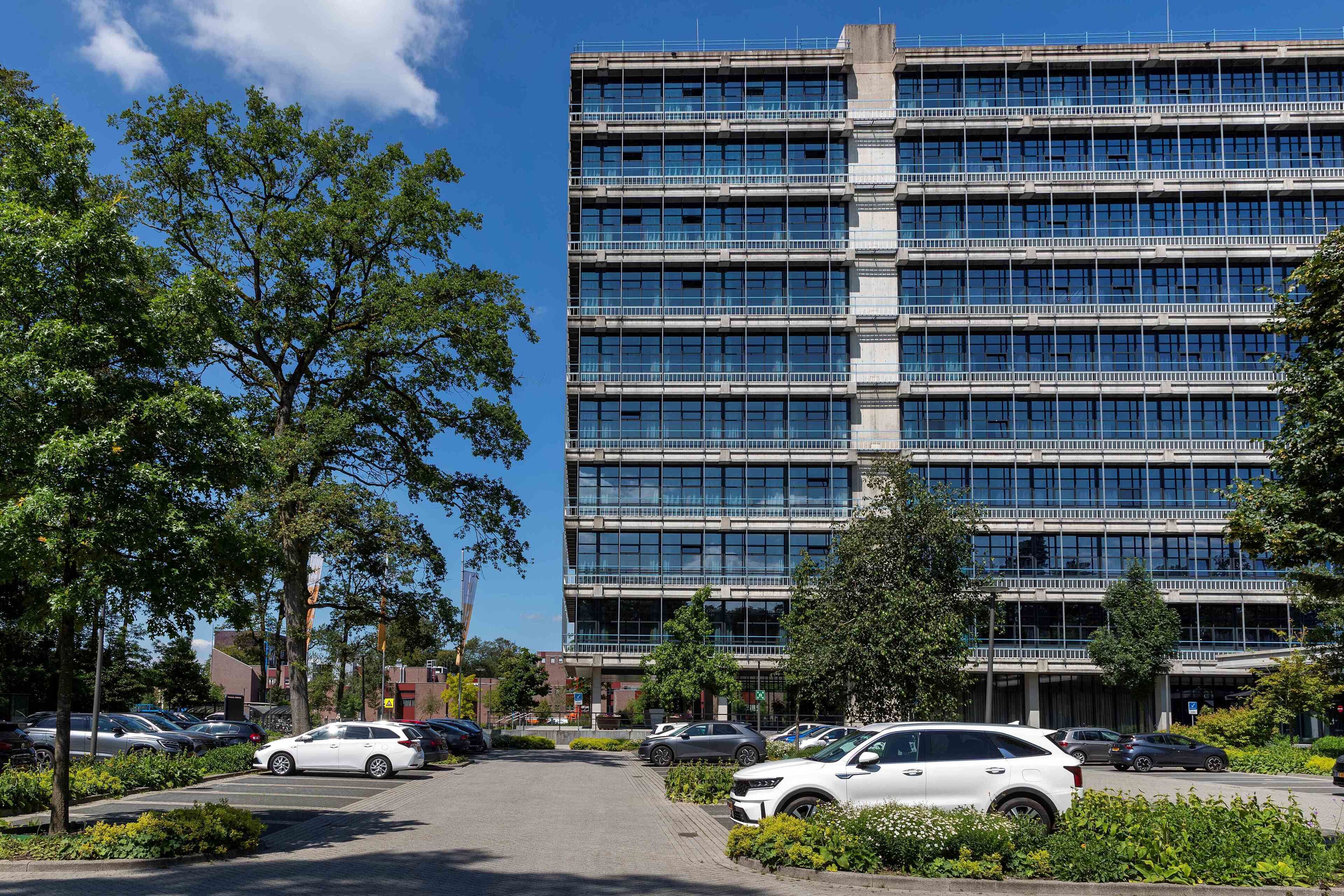 A multi-story parking garage with several cars parked.
