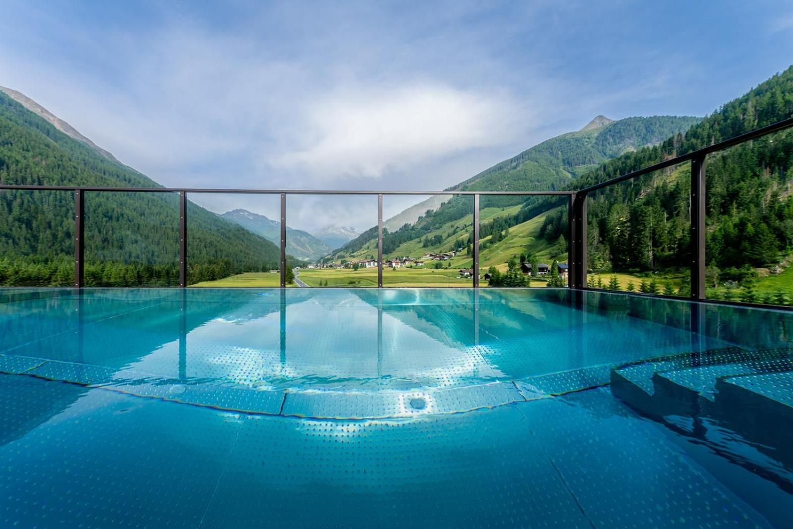 A clear blue pool with a view of a mountainous landscape.