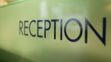 A reception sign with the word "RECEPTION" in capital letters.