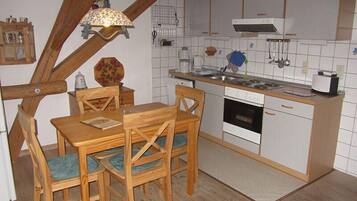 Standard Apartment | Private kitchen | Stovetop, dishwasher, cookware/dishes/utensils