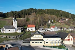 A village with a church, residential buildings, and a road.