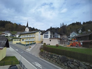 A residential street with houses, a church, and a playground.