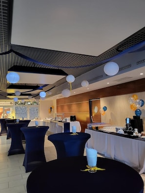A banquet hall with round tables, a buffet setup, and ceiling decorations. - Hotel Kolna (Kraków)