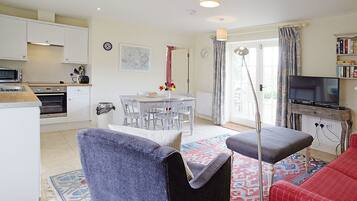A compact living space with a kitchenette, dining area, and seating area.