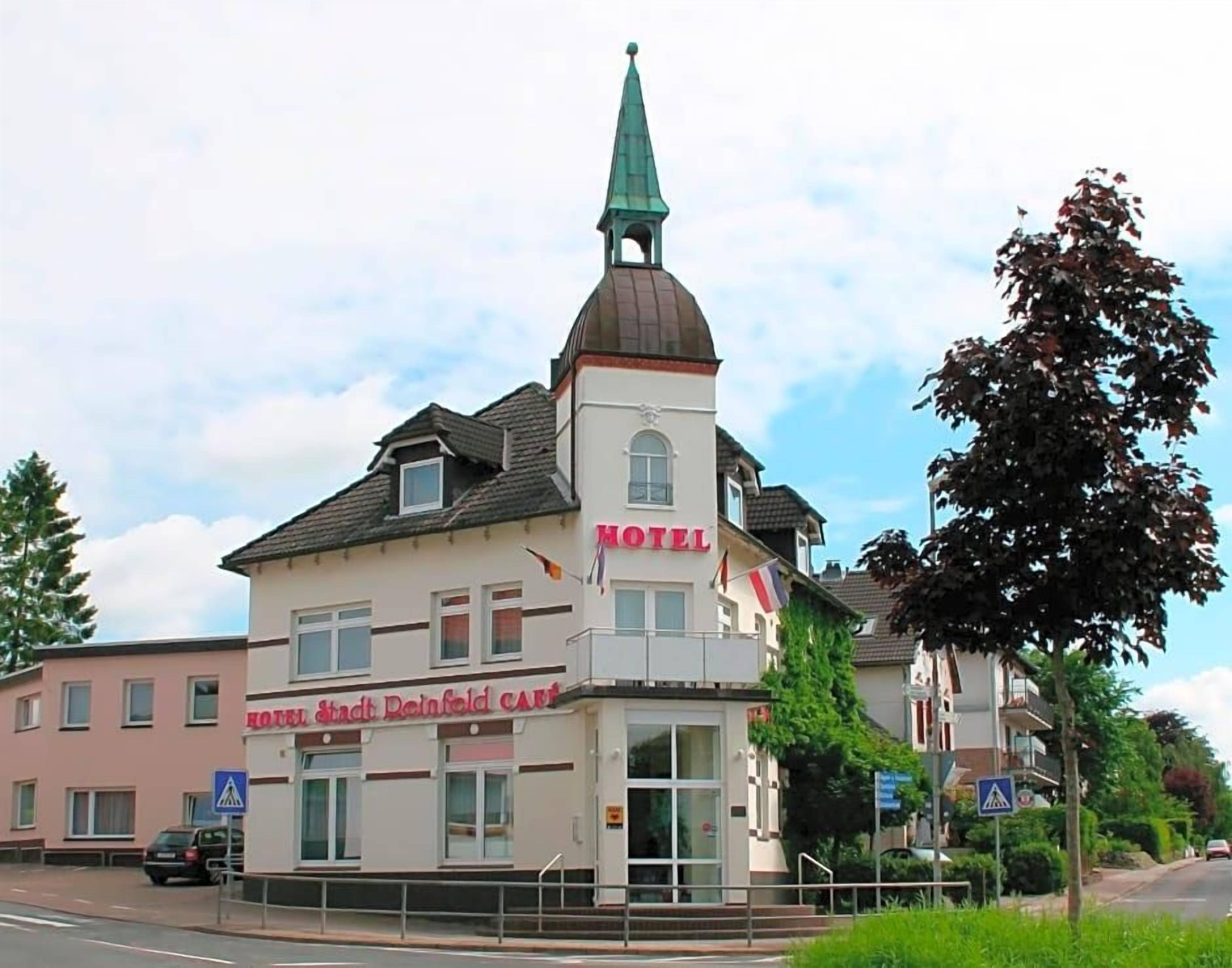 A hotel with a prominent tower and a sign indicating it is a hotel.