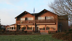 A two-story building with a sign reading "Seestube." - Hotel Seeblick Garni (Gartow)
