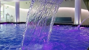 A modern indoor pool with a flowing water feature. - Costa Brada (Gallipoli)
