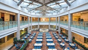 A spacious atrium with multiple levels, a central fountain, and numerous seating areas.