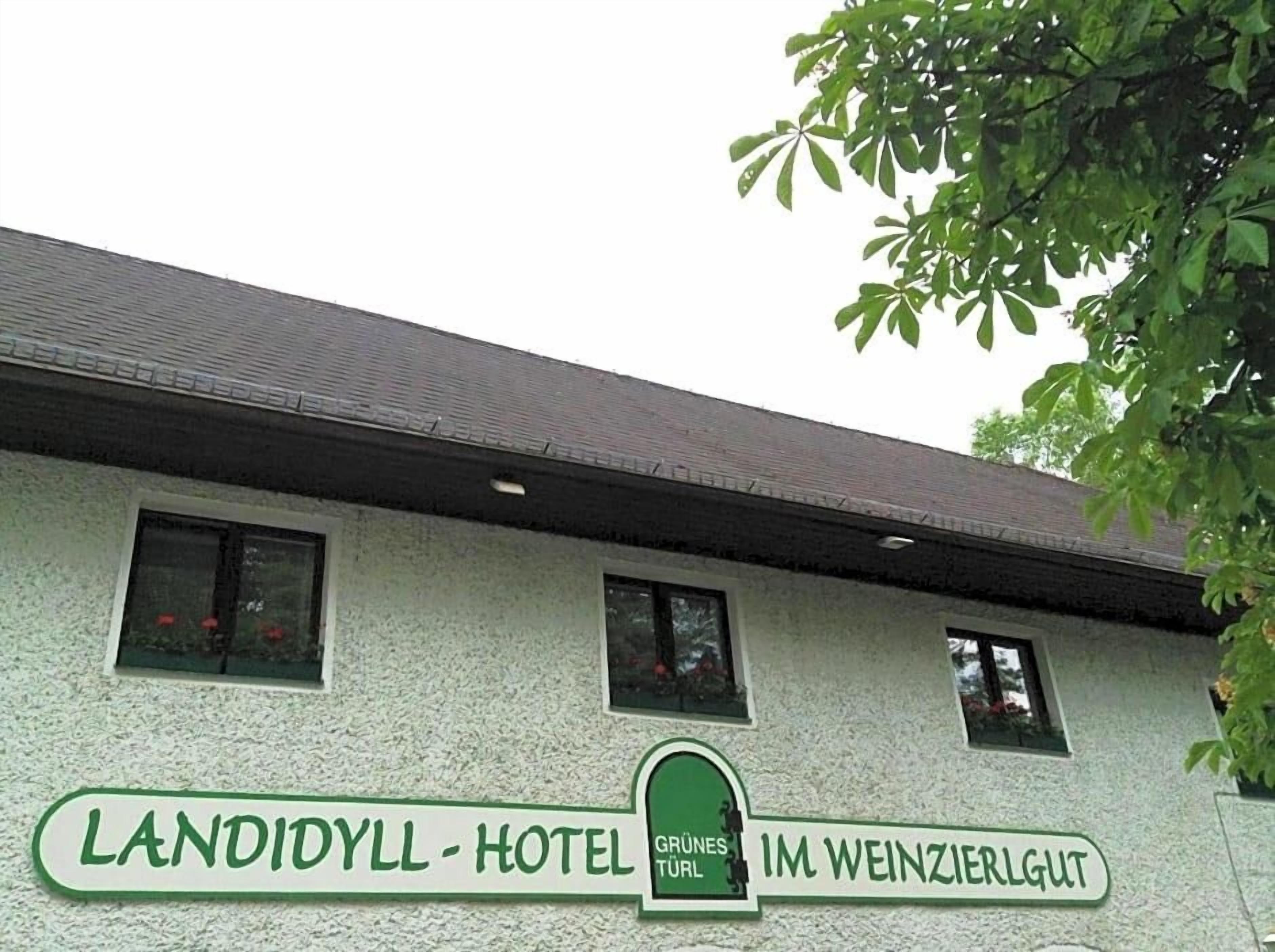 A building with a sign that reads 'LANDIYYL - HOTEL GRÜNES TÜR IM WEINZIERLGUT.'
