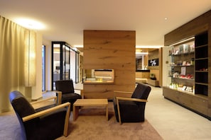 En moderne hotellobby med reception, siddeområde og et udvalg af faciliteter.