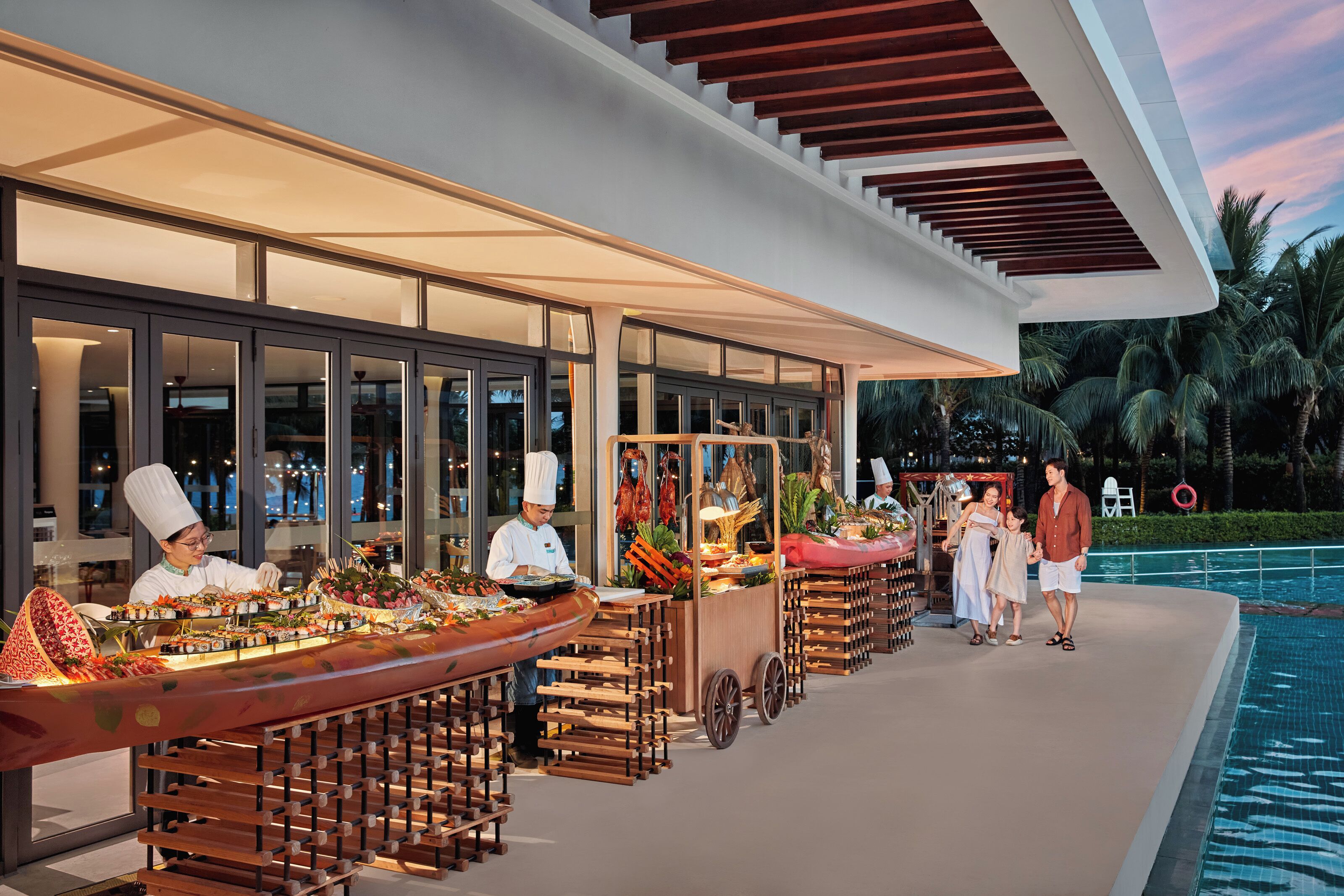 A buffet setup with multiple food stations and a poolside area.