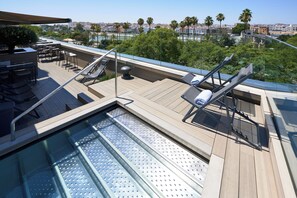 Outdoor pool, open 11:30 AM to 8:00 PM, pool loungers