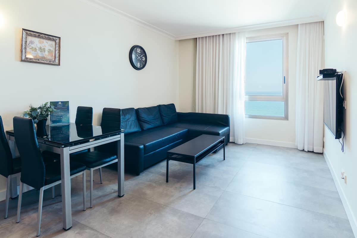 Deluxe Apartment, 1 Bedroom, Sea View, Beachfront | Living area | TV