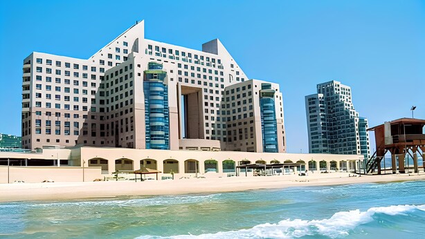 A large hotel with multiple floors and a beachside location. - Almog Beach (Haifa)