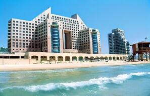 A large hotel with multiple floors and a beachside location. - Almog Beach (Haifa)