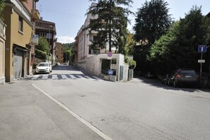 A street view with buildings, a pedestrian crossing, and a no parking sign.