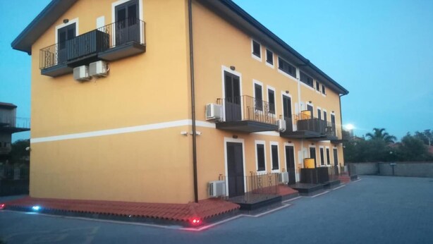 Un immeuble de deux étages doté de balcons et de climatiseurs.
