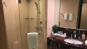 A bathroom with a glass-enclosed shower, a marble sink, and a mirror. - Jinling Netda Hotel (Nantong)