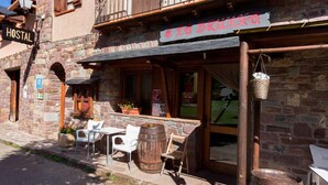 A rustic stone building with a sign reading "Hostal" and "La Bruyha". - Casa Francho (Laspaules)