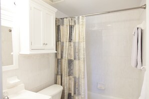 Combined shower/bathtub, deep-soaking bathtub, towels