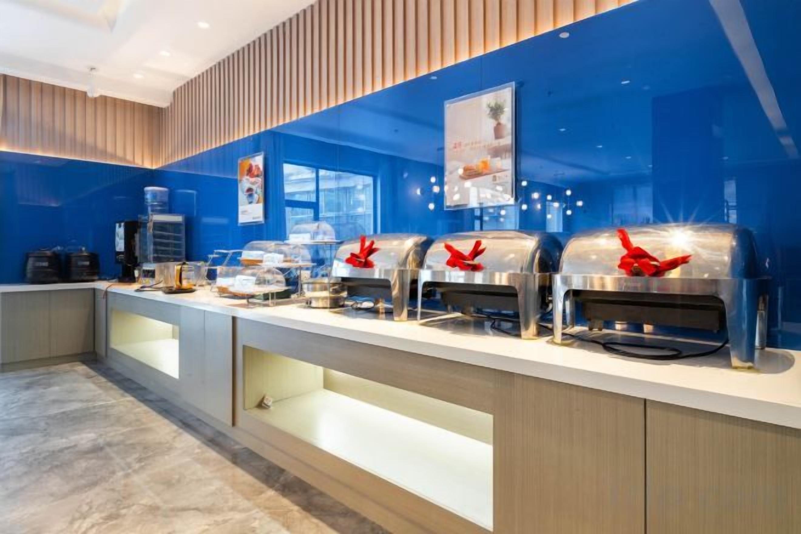 A buffet setup with multiple self-service stations, a water dispenser, and a coffee machine.