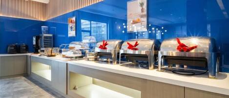A buffet setup with multiple self-service stations, a water dispenser, and a coffee machine.