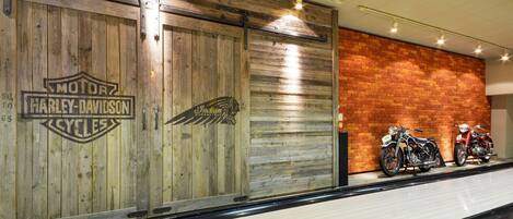 Pared de madera con logotipos de Harley-Davidson y pared de ladrillo con motocicletas.