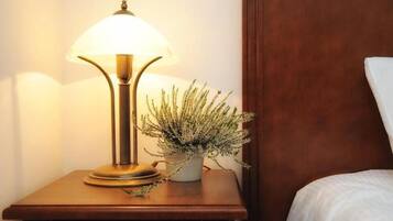 A bedside table with a lamp and a potted plant.