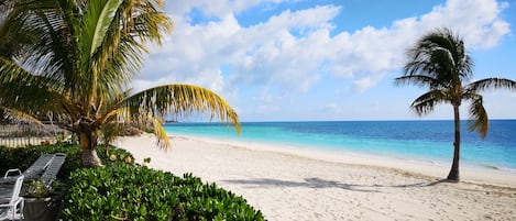 On the beach, white sand, free beach cabanas, sun loungers