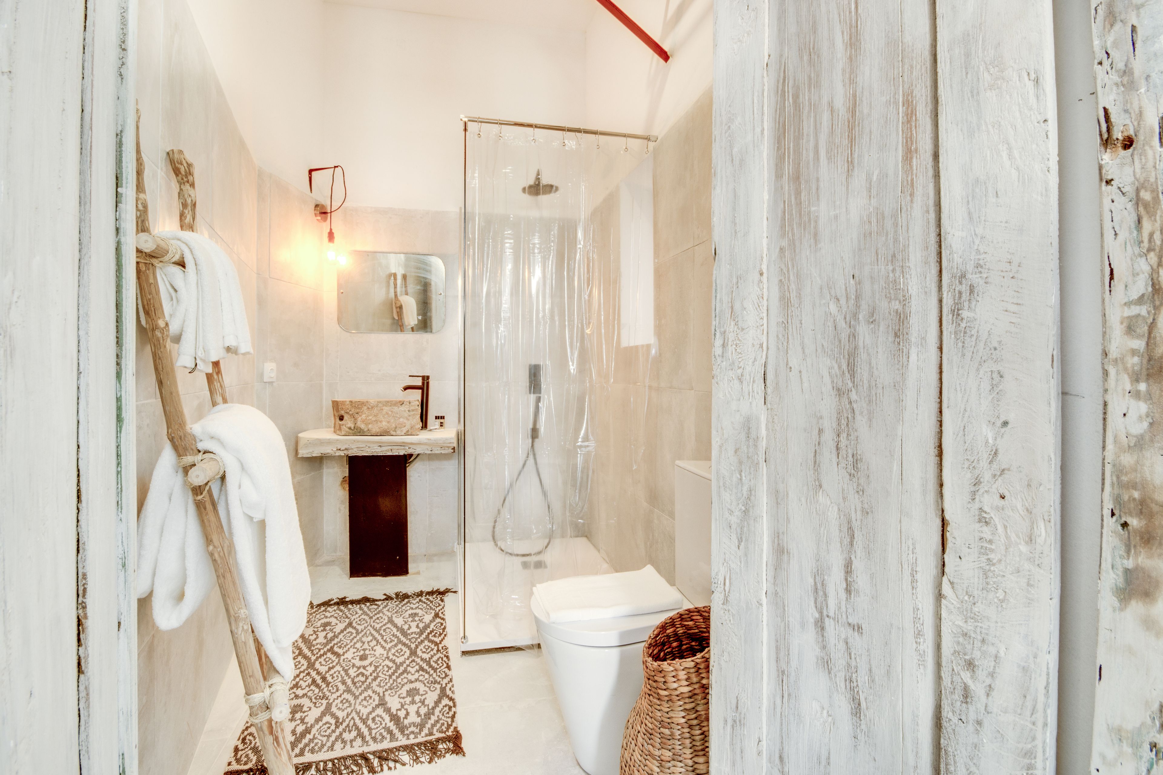 A bathroom with a shower, toilet, and sink.