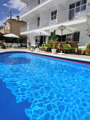 Seasonal outdoor pool, pool umbrellas, pool loungers