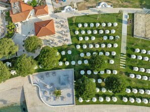 An aerial view of a hotel with multiple outdoor seating areas, a pool, and a landscaped garden. - Hotel Vile Park Premium (Piran)