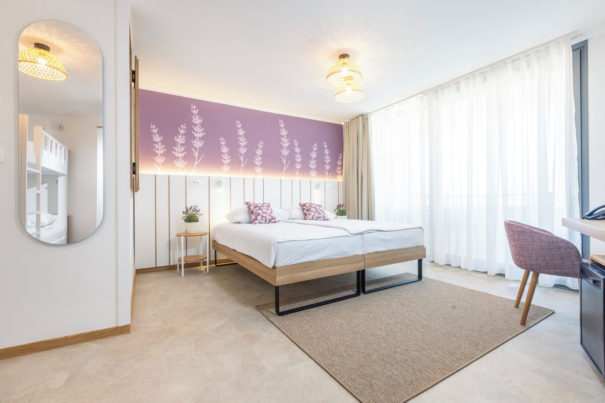 A modern bedroom with a bed, bedside table, and a chair.