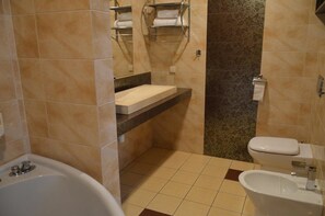 A bathroom with a bathtub, a sink, and a toilet.