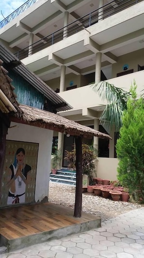 A multi-story building with a central courtyard. - Sauraha Boutique Resort (Sauraha)