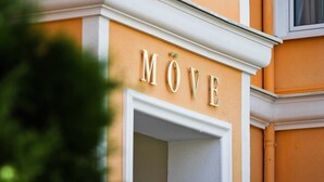 A building facade with the word "MÖVE" in large, gold letters.