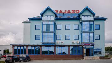 A building with a sign reading 'ZAJAZD' and a restaurant named 'ZAJAZD Bistro'.